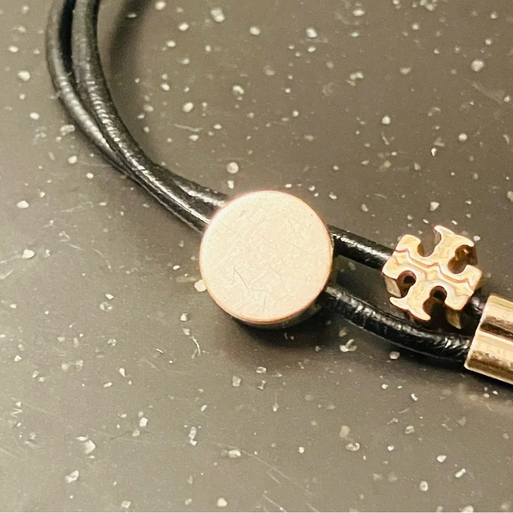 Tory Burch-Kira Double Leather Slider Bracelet in Black and Gold. Shows min wear